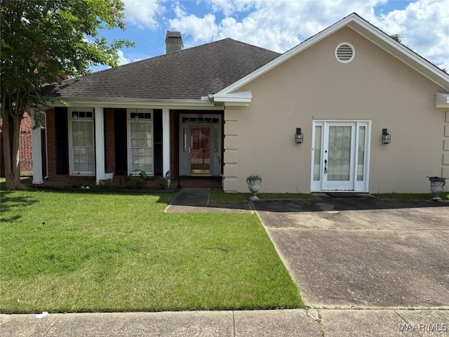 3504 Summerhill Dr, Montgomery, AL 36111 - view of front of property with stucco siding, a chimney, a front yard, and a shingled roof