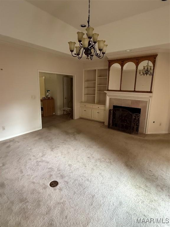 3504 Summerhill Dr, Montgomery, AL 36111 - unfurnished living room with carpet floors, a chandelier, built in shelves, a fireplace with flush hearth, and a towering ceiling