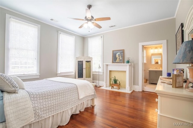 231 E Main St, Prattville, AL 36067 - bedroom with wood finished floors, baseboards, crown molding, a fireplace, and ceiling fan