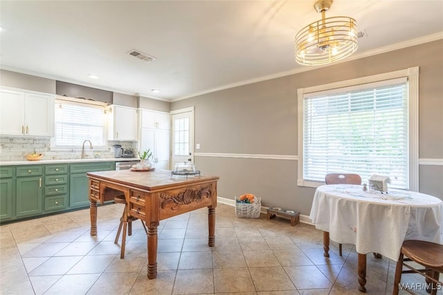 231 E Main St, Prattville, AL 36067 - kitchen with green cabinetry, light countertops, backsplash, a sink, and light tile patterned flooring