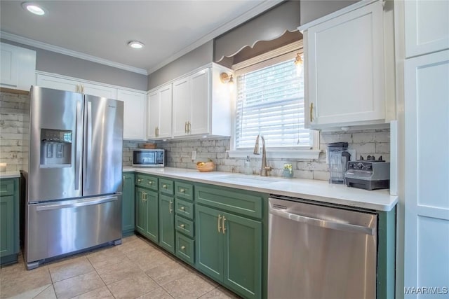 231 E Main St, Prattville, AL 36067 - kitchen with stainless steel appliances, green cabinets, a sink, white cabinets, and light countertops