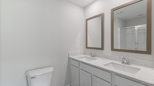 6004 Cunningham Trl, Montgomery, AL 36116 - full bathroom featuring toilet, double vanity, and an enclosed shower