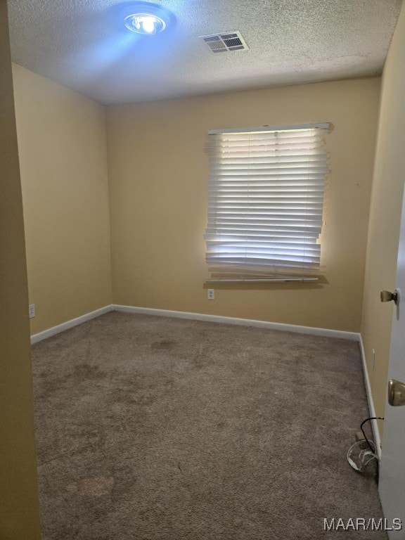 116 Longbrook Dr, Montgomery, AL 36110 - spare room featuring a textured ceiling, carpet, and baseboards