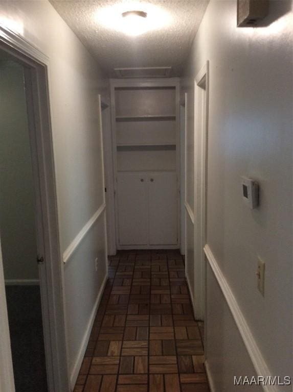 4037 Piedmont Dr, Montgomery, AL 36108 - hall featuring a textured ceiling and brick patterned flooring