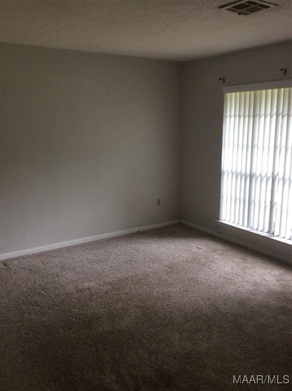 4037 Piedmont Dr, Montgomery, AL 36108 - carpeted spare room featuring baseboards and a textured ceiling