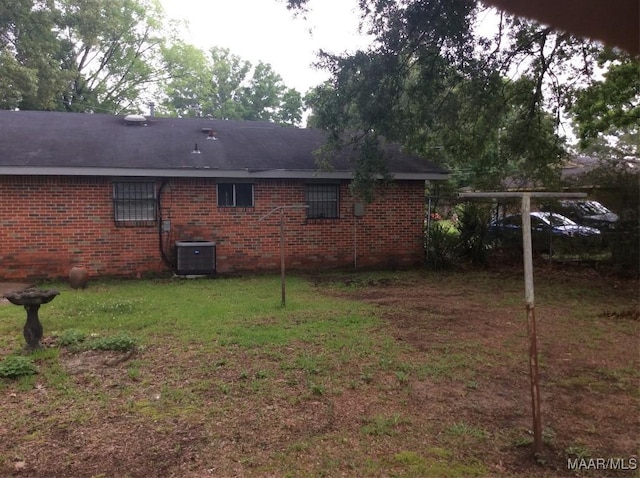 4037 Piedmont Dr, Montgomery, AL 36108 - view of side of property with central AC, brick siding, and a lawn