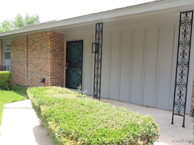 5314 Rolind Dr, Montgomery, AL 36108 - view of exterior entry with board and batten siding and brick siding