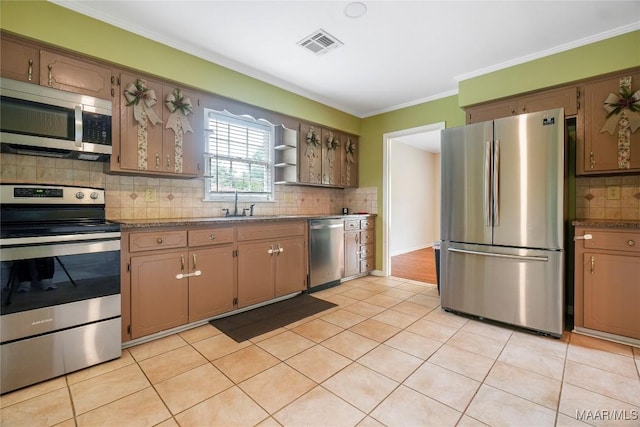 738 Forestdale Dr, Montgomery, AL 36109 - kitchen featuring stainless steel appliances, backsplash, ornamental molding, a sink, and light tile patterned flooring