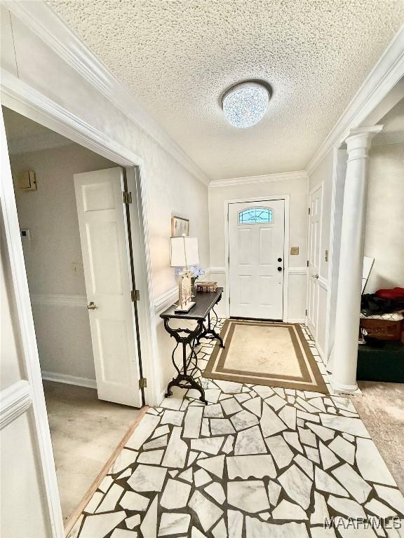 36 Wilkins Rd, Selma, AL 36701 - foyer entrance featuring ornamental molding, ornate columns, and a textured ceiling