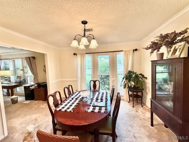 36 Wilkins Rd, Selma, AL 36701 - dining room with light colored carpet, a chandelier, a textured ceiling, healthy amount of natural light, and crown molding