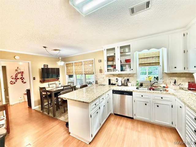 36 Wilkins Rd, Selma, AL 36701 - kitchen with stainless steel dishwasher, a peninsula, light wood-style flooring, a sink, and plenty of natural light