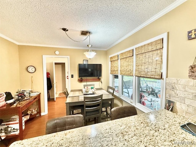 36 Wilkins Rd, Selma, AL 36701 - dining area with wood finished floors, a textured ceiling, and ornamental molding