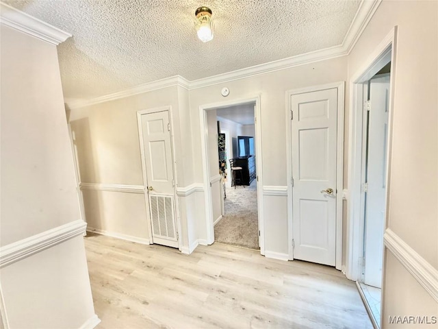 36 Wilkins Rd, Selma, AL 36701 - hall with light wood-style floors, a textured ceiling, and ornamental molding