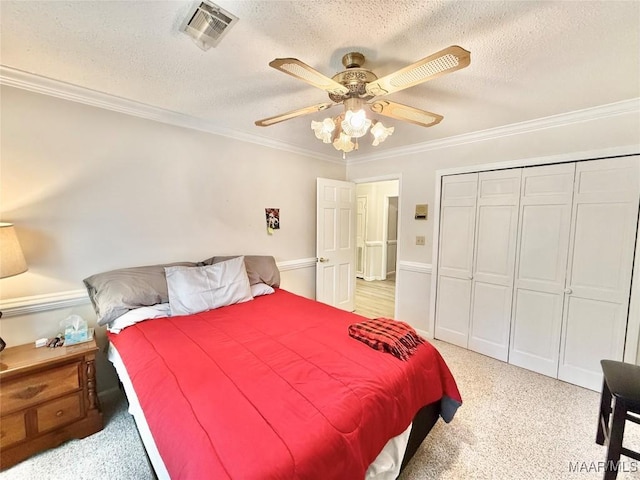 36 Wilkins Rd, Selma, AL 36701 - bedroom with ornamental molding, a textured ceiling, light carpet, ceiling fan, and a closet
