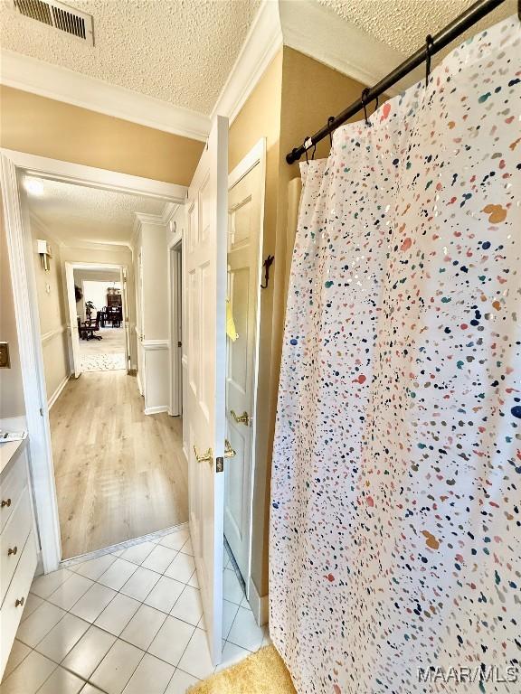 36 Wilkins Rd, Selma, AL 36701 - full bath featuring ornamental molding, curtained shower, a textured ceiling, tile patterned floors, and vanity