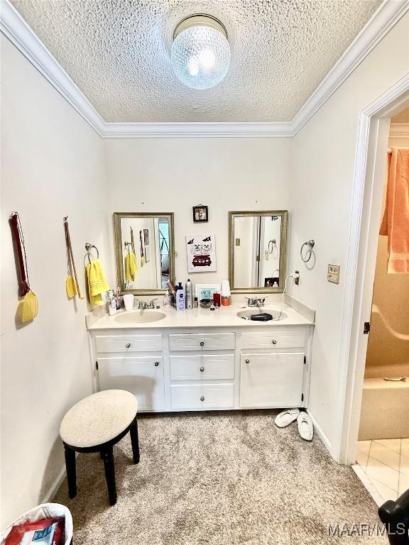 36 Wilkins Rd, Selma, AL 36701 - bathroom with a textured ceiling, double vanity, ornamental molding, a shower, and a bathtub
