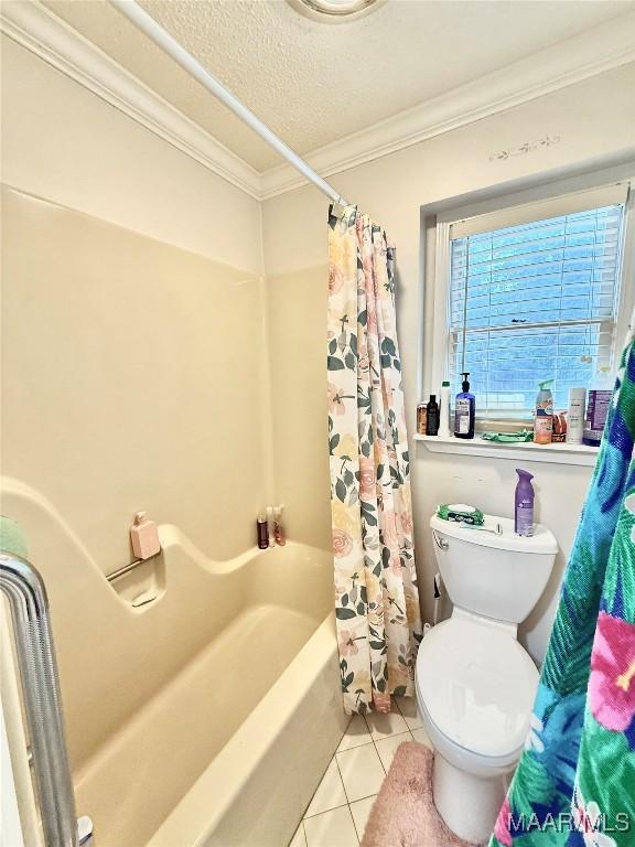 36 Wilkins Rd, Selma, AL 36701 - bathroom featuring crown molding, tile patterned floors, shower / tub combo with curtain, toilet, and a textured ceiling