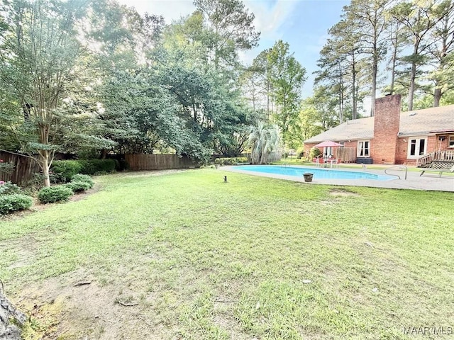 36 Wilkins Rd, Selma, AL 36701 - view of yard with an outdoor pool, a patio area, and view of wooded area