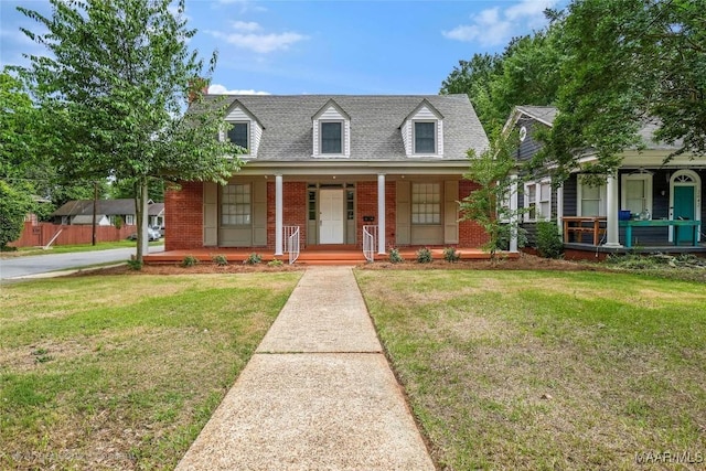 2046 Madison Ave, Montgomery, AL 36107 - cape cod home with a porch, brick siding, and a front yard