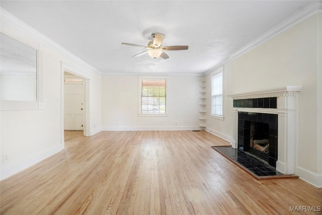 2046 Madison Ave, Montgomery, AL 36107 - unfurnished living room featuring light wood-type flooring, a ceiling fan, a fireplace, ornamental molding, and baseboards