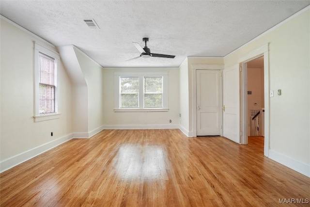 2046 Madison Ave, Montgomery, AL 36107 - unfurnished living room featuring light wood-style floors, a textured ceiling, baseboards, and ceiling fan