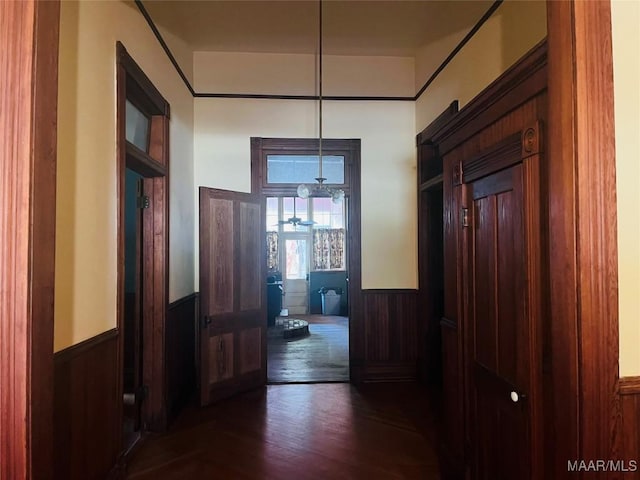 501 Tremont St, Selma, AL 36701 - hallway with a wainscoted wall, wood walls, and dark wood-type flooring
