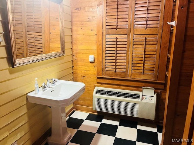 501 Tremont St, Selma, AL 36701 - bathroom featuring tile patterned floors, wood walls, and a wall unit AC