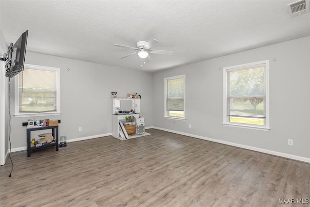 57 New Harmony Rd, Deatsville, AL 36022 - spare room with a ceiling fan, wood finished floors, healthy amount of natural light, and a textured ceiling