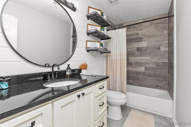 57 New Harmony Rd, Deatsville, AL 36022 - bathroom with tile patterned flooring, toilet, vanity, shower / tub combo, and a textured ceiling