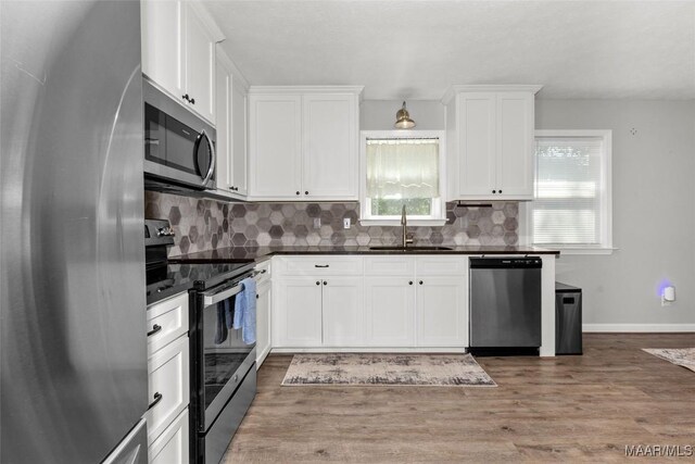57 New Harmony Rd, Deatsville, AL 36022 - kitchen featuring appliances with stainless steel finishes, a sink, decorative backsplash, and white cabinets
