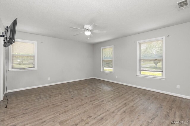57 New Harmony Rd, Deatsville, AL 36022 - spare room with a ceiling fan, wood finished floors, a textured ceiling, and baseboards