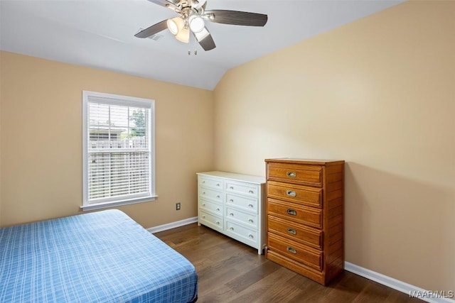 bedroom featuring dark wood-style flooring, lofted ceiling, baseboards, and a ceiling fan