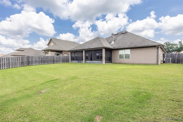 rear view of property featuring a sunroom, central AC unit, and roof with shingles