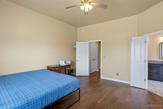 bedroom with wood finished floors, baseboards, a ceiling fan, and lofted ceiling