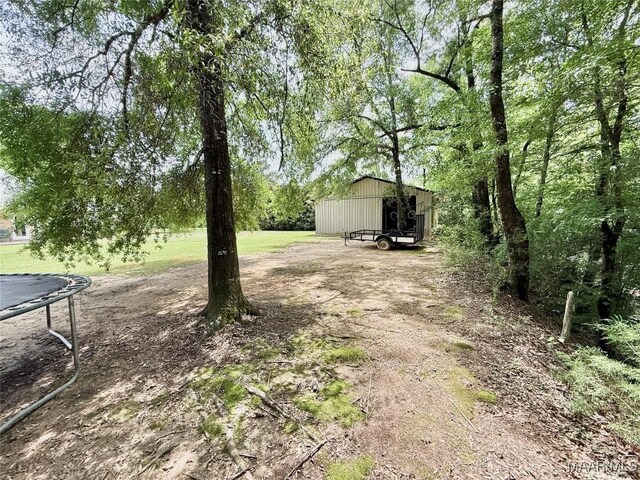 828 Warrior Dr, Valley Grande, AL 36701 - view of yard with a trampoline and an outbuilding