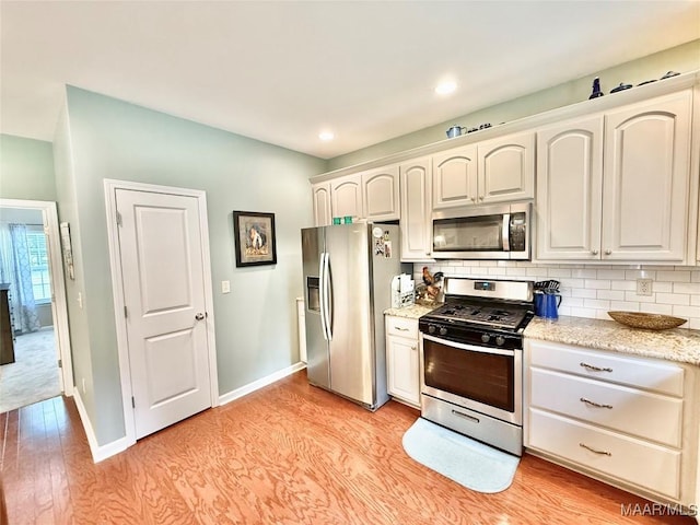 828 Warrior Dr, Valley Grande, AL 36701 - kitchen with stainless steel appliances, tasteful backsplash, light wood-style flooring, baseboards, and recessed lighting