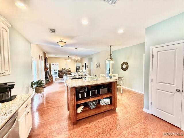 828 Warrior Dr, Valley Grande, AL 36701 - kitchen with open shelves, light wood finished floors, dishwasher, open floor plan, and recessed lighting