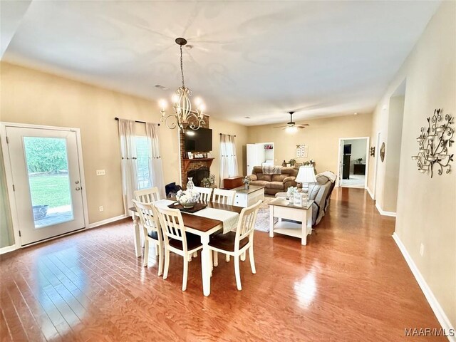 828 Warrior Dr, Valley Grande, AL 36701 - dining room featuring wood finished floors, a chandelier, baseboards, and a ceiling fan