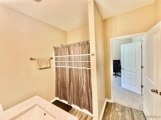 828 Warrior Dr, Valley Grande, AL 36701 - bathroom featuring wood finished floors, baseboards, and curtained shower