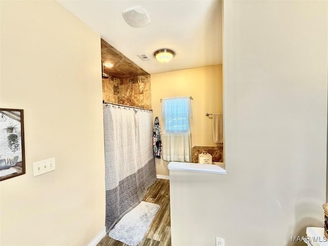 828 Warrior Dr, Valley Grande, AL 36701 - bathroom featuring a tile shower, baseboards, and wood finished floors
