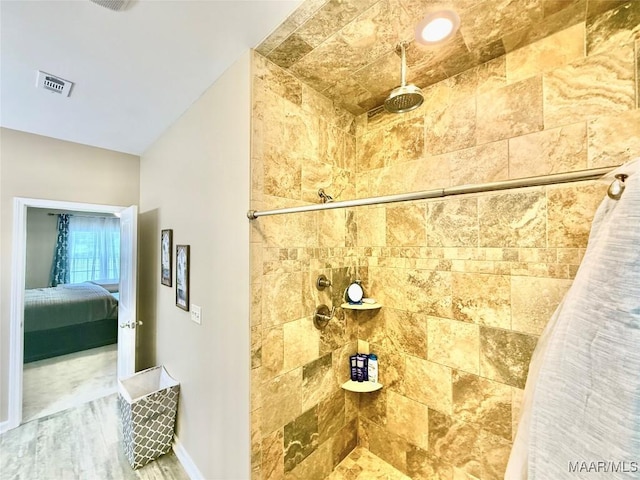 828 Warrior Dr, Valley Grande, AL 36701 - ensuite bathroom featuring tiled shower, wood finished floors, and baseboards