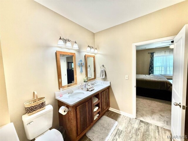 828 Warrior Dr, Valley Grande, AL 36701 - ensuite bathroom featuring wood finished floors, toilet, baseboards, and double vanity