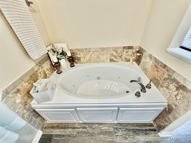 828 Warrior Dr, Valley Grande, AL 36701 - full bath featuring a jetted tub and wood finished floors