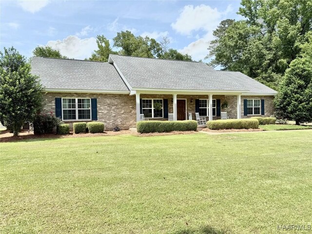 828 Warrior Dr, Valley Grande, AL 36701 - view of front of home with a front lawn, covered porch, brick siding, and roof with shingles