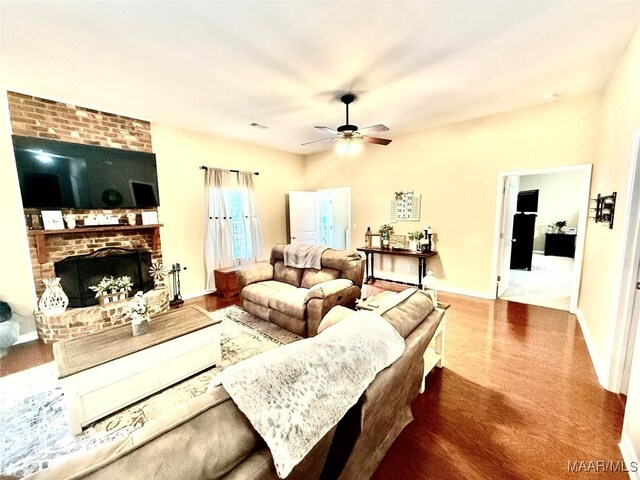828 Warrior Dr, Valley Grande, AL 36701 - living room featuring a ceiling fan, wood finished floors, baseboards, and a fireplace