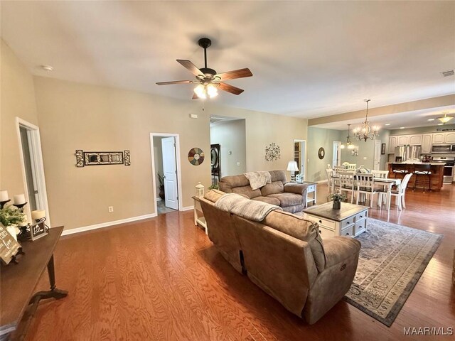 828 Warrior Dr, Valley Grande, AL 36701 - living area with a ceiling fan, wood finished floors, a chandelier, and baseboards