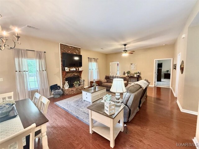 828 Warrior Dr, Valley Grande, AL 36701 - living room with dark wood-type flooring, healthy amount of natural light, a fireplace, and ceiling fan