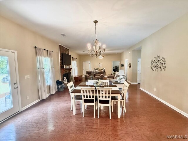 828 Warrior Dr, Valley Grande, AL 36701 - dining room featuring a chandelier, dark wood-style floors, and baseboards