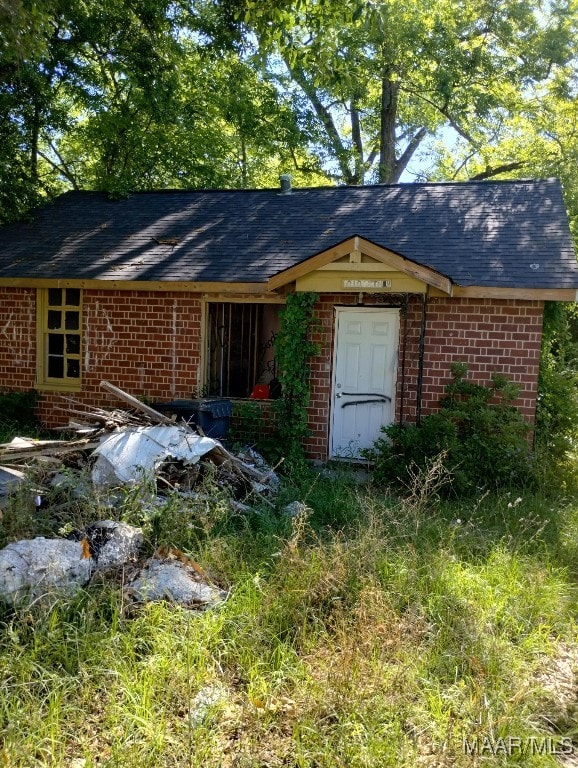 1010 12th Ave, Phenix City, AL 36867 - view of side of property featuring brick siding and roof with shingles