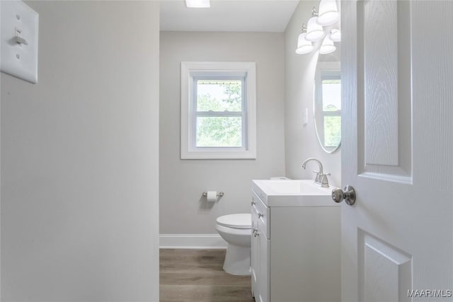 3468 Biltmore Ave, Montgomery, AL 36109 - bathroom with wood finished floors, vanity, toilet, baseboards, and a chandelier